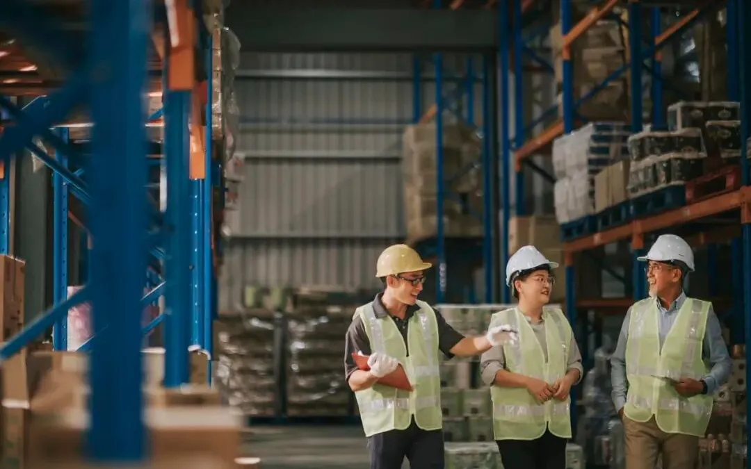 Operators in a warehouse discussing business operations.